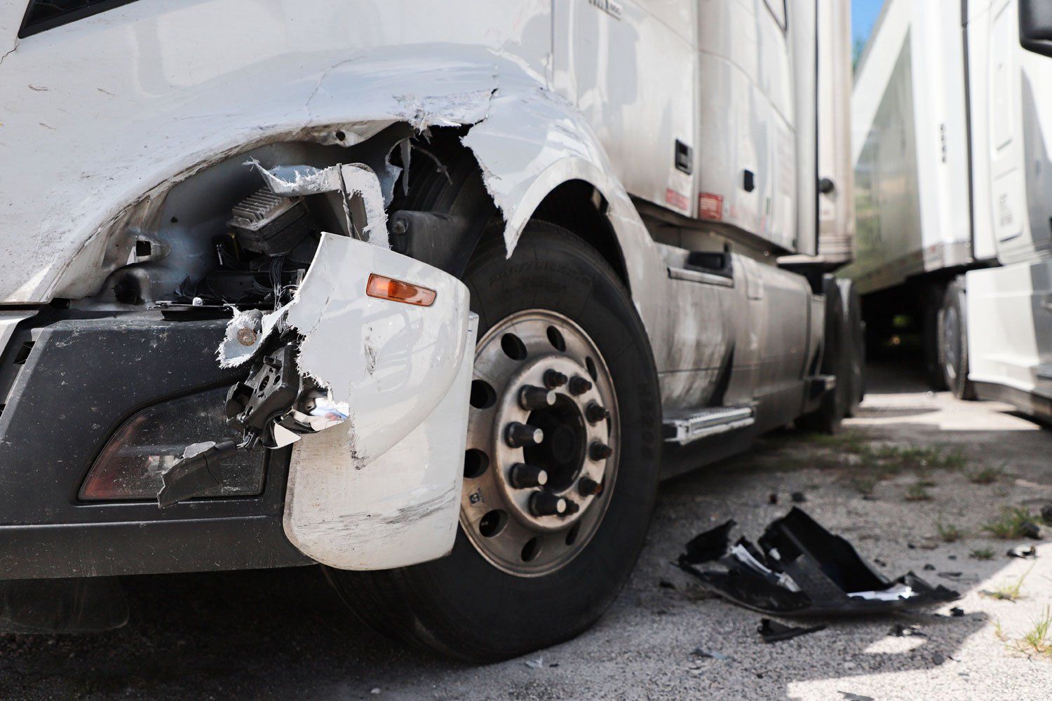 Damaged white semi-truck and roadway debris after a serious commercial truck accident in Ohio.